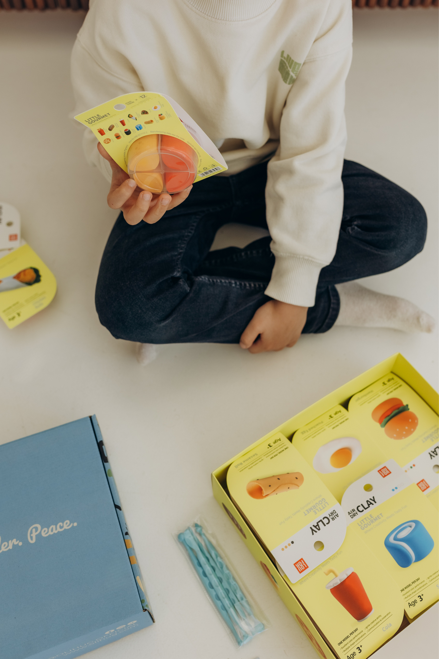 Cozy Montessori-inspired scene with a young child creating clay figures from the OLIHUG Air Dry Clay Kit. Encourages imaginative play, emotional connection, and fine motor development. Trusted by creative families worldwide for bringing peace, joy, and connection through mindful art at home.